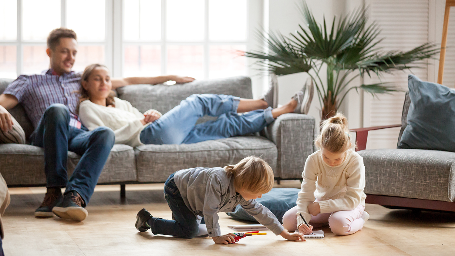 Family sitting in cool home