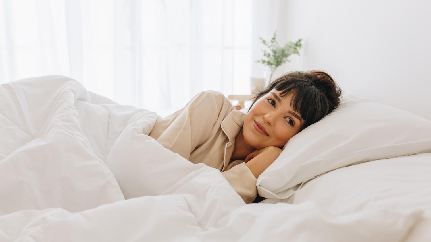 Woman lying on bed at home