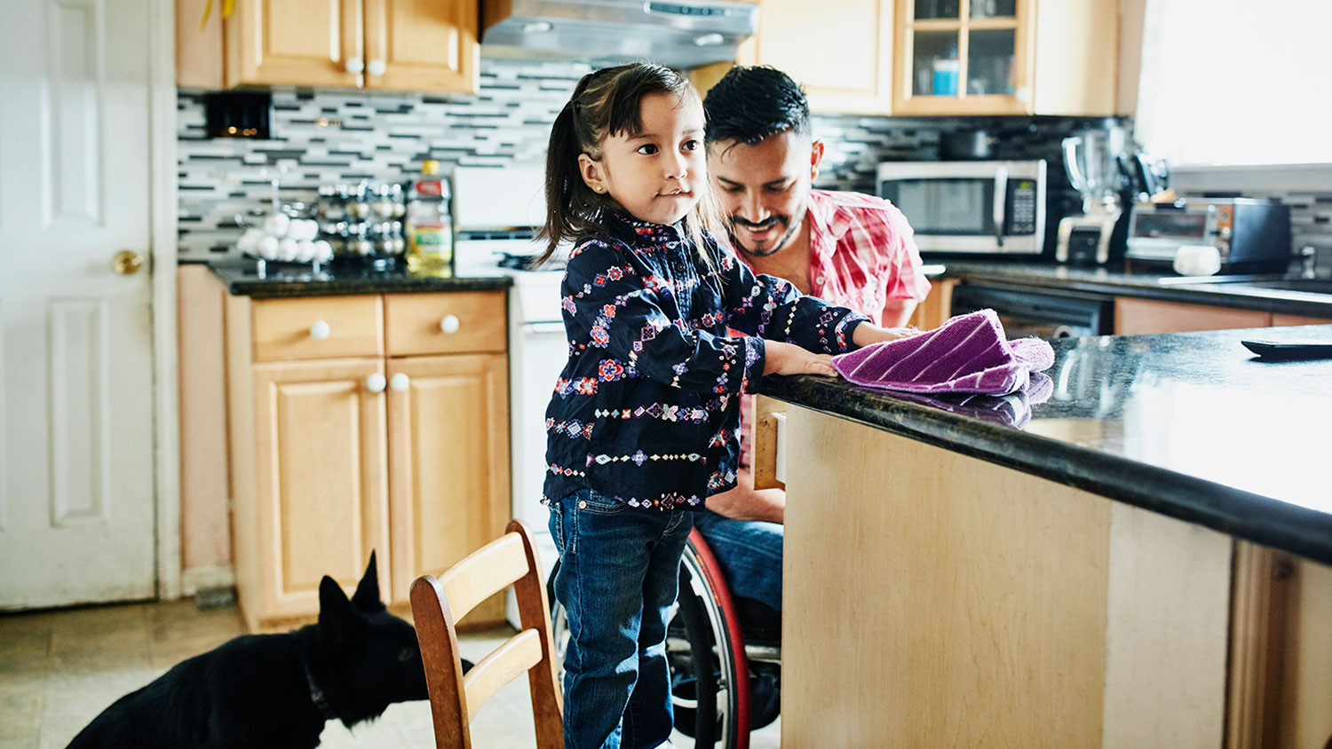 Father and daughter cleaning kitchen
