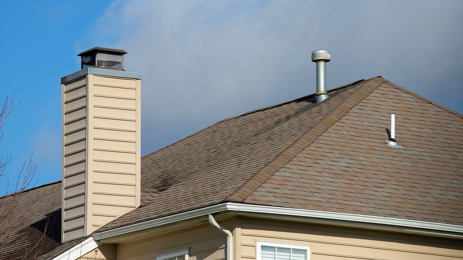 A galvanised metal chimney with a rain cap