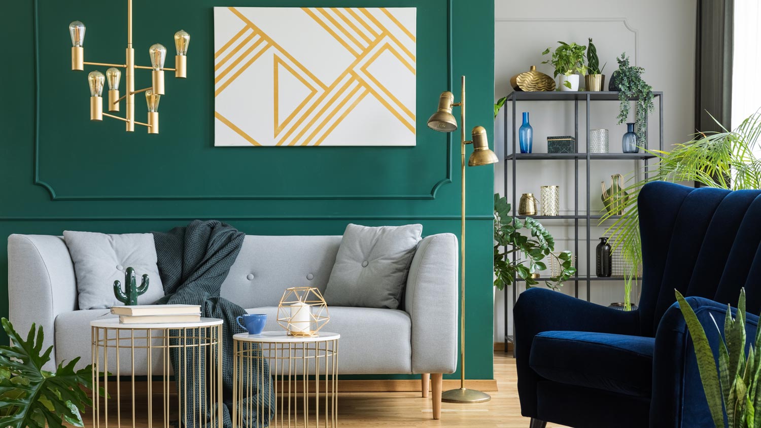 A living room with a sofa, an armchair and a golden light fixture