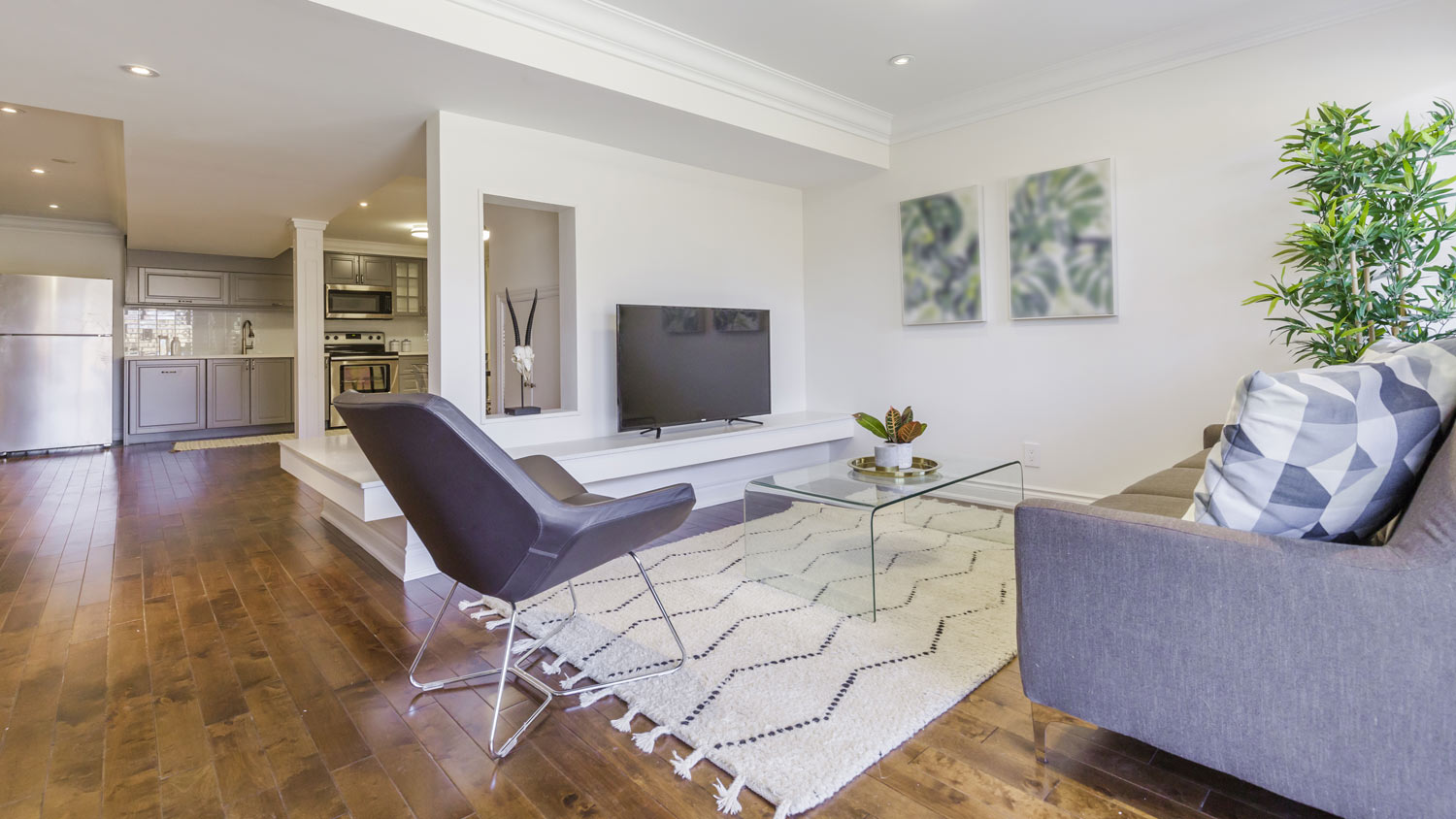 An open-space living room and kitchen located in a house’s basement