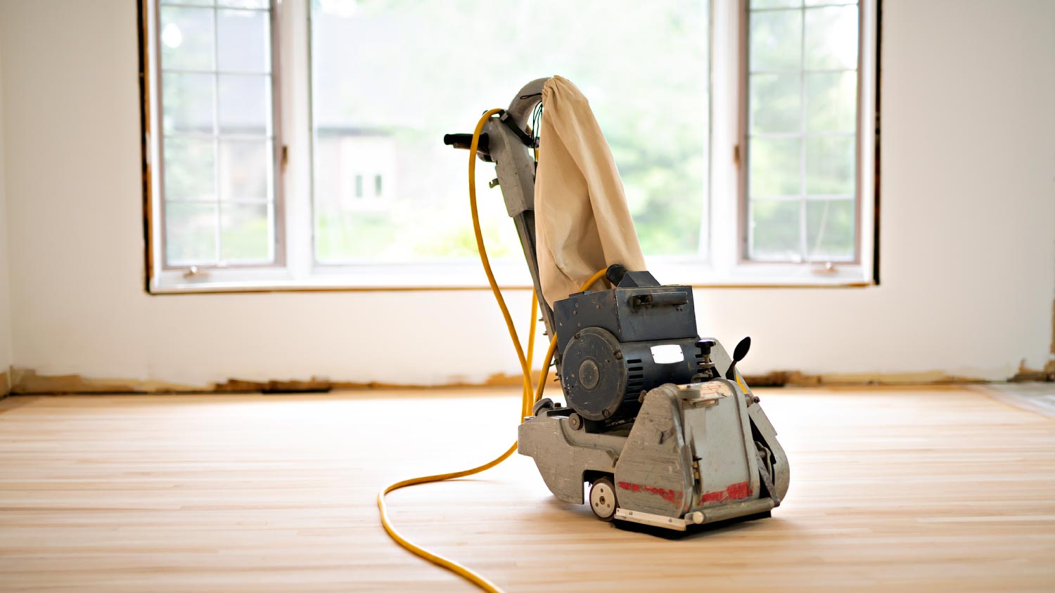 A sanding hardwood floor with the grinding machine