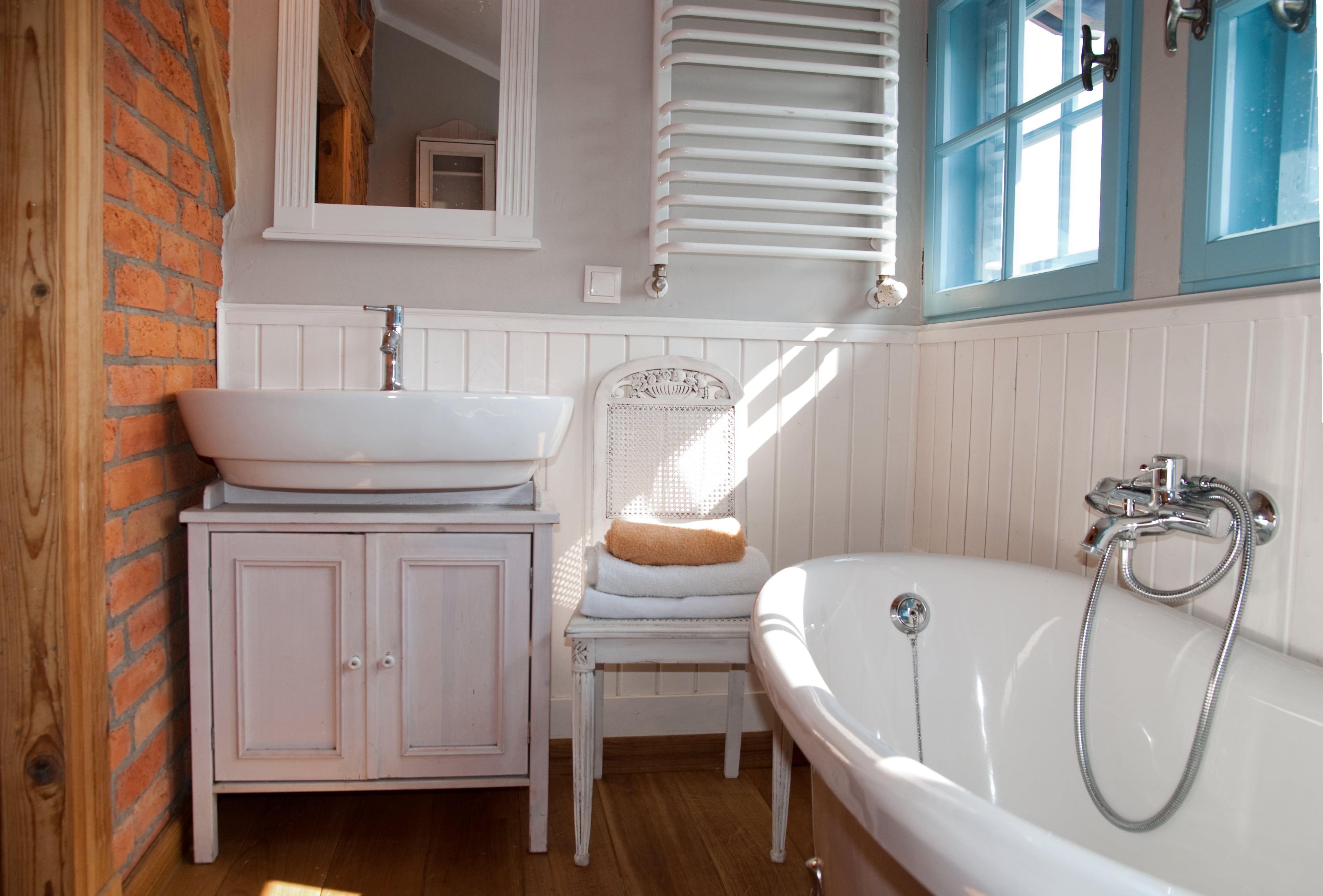 Small bathroom wall lined with beadboard wainscoting