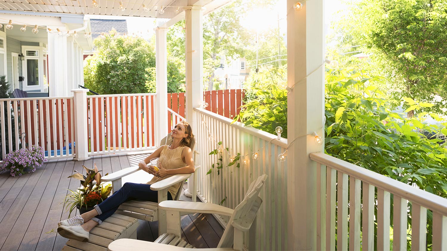 Woman relaxing in a chair on porch.